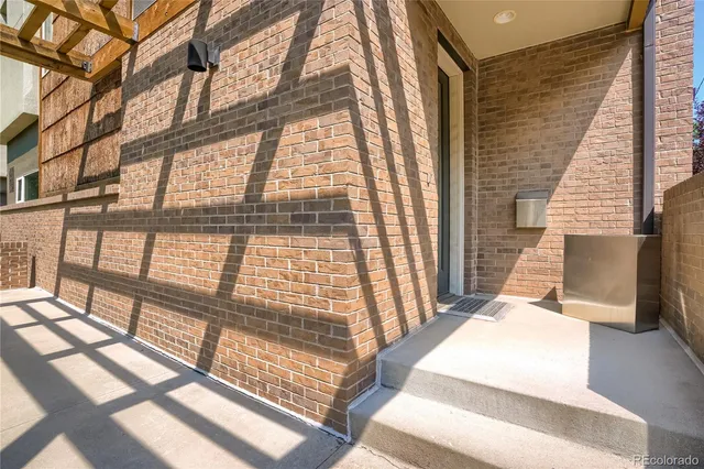 a bedroom with a bed and large windows