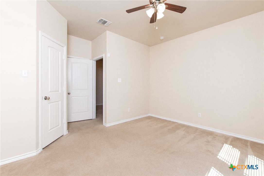3302 Vineyard Trail Harker Heights, TX 76548 - Photo 26 of 29 an empty room with a chandelier fan and closet