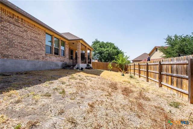 a view of house with yard and covered with snow