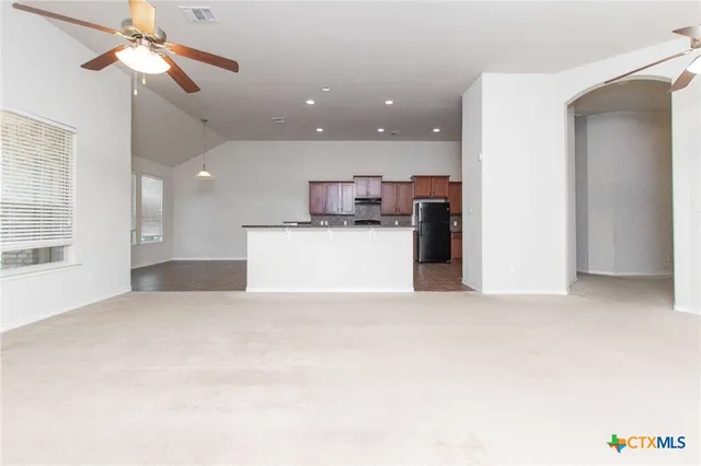 a view of a kitchen with a sink and a refrigerator
