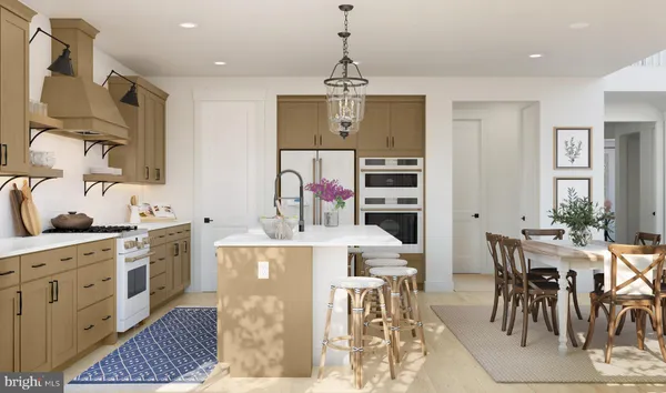 a kitchen with stainless steel appliances a dining table and chairs