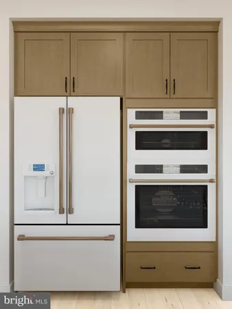 a stove top oven sitting inside of a kitchen