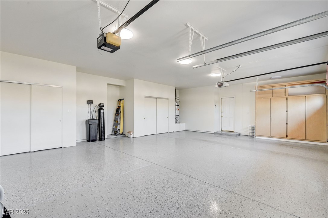 2955 El Camino Road Las Vegas, NV 89146 - Photo 33 of 99 Garage with a garage door opener and water heater