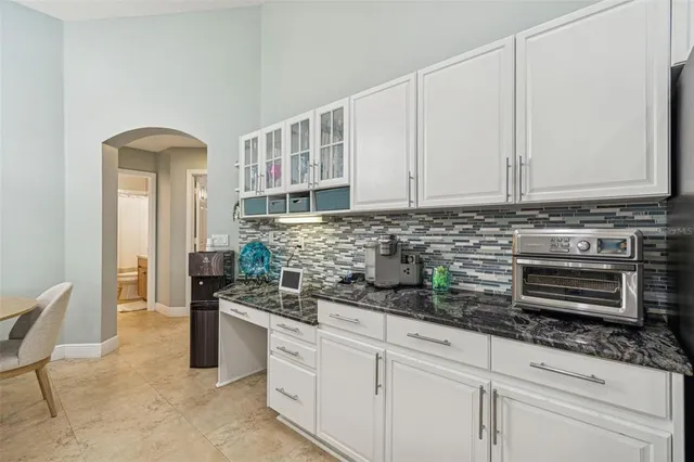 a bedroom with a large bed and a chandelier
