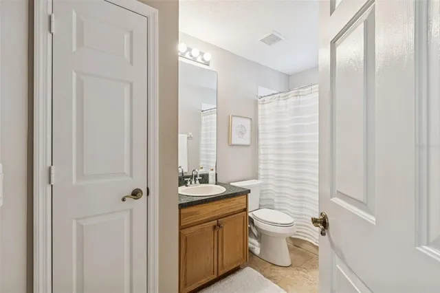 a spacious bathroom with a granite countertop tub sink and mirror