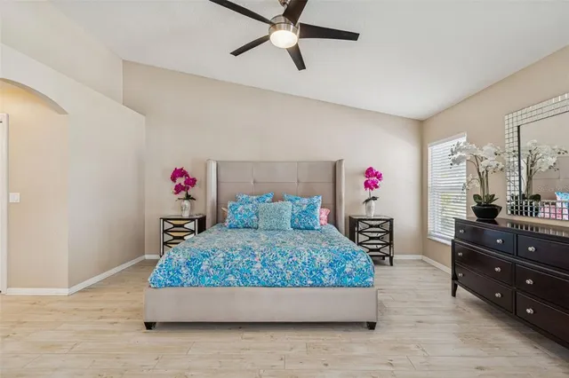 an aerial view of residential houses with outdoor space and trees