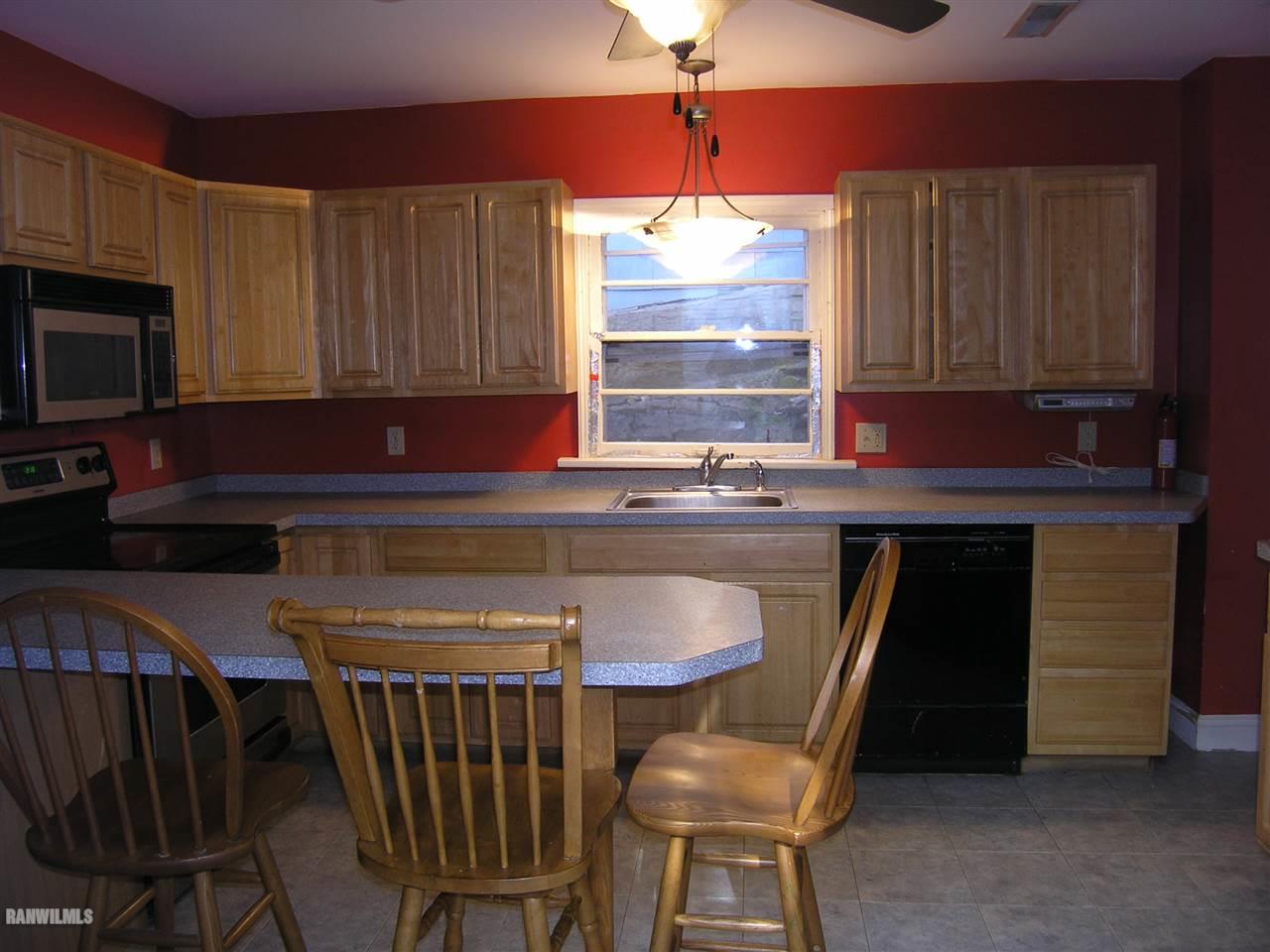 313 South Bench Street Galena, IL 61036 - Photo 16 of 19 a kitchen with stainless steel appliances granite countertop a sink a microwave refrigerator and chairs