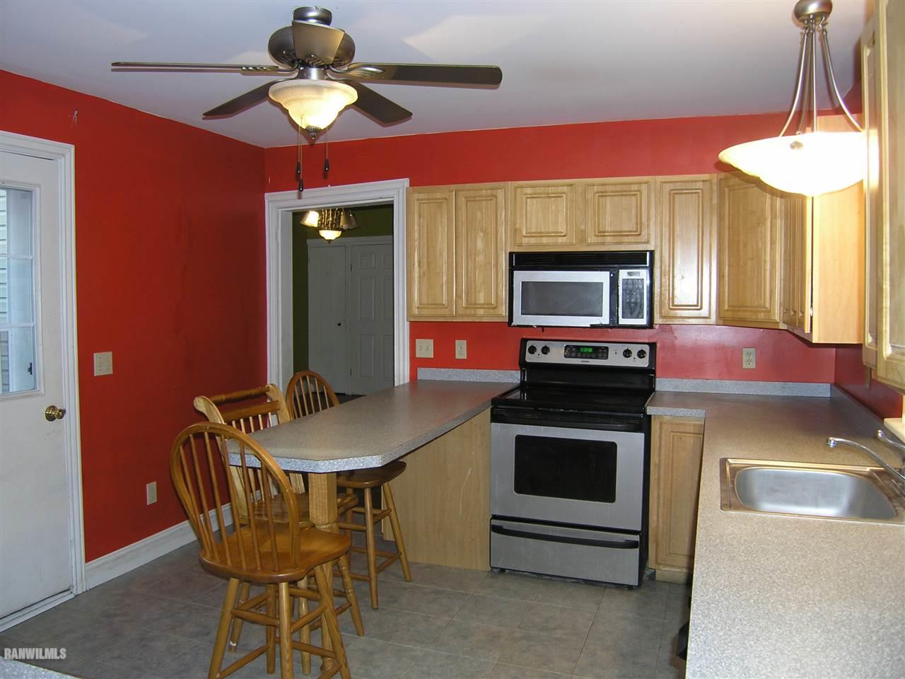 313 South Bench Street Galena, IL 61036 - Photo 5 of 19 a dining room with a fireplace and a chandelier