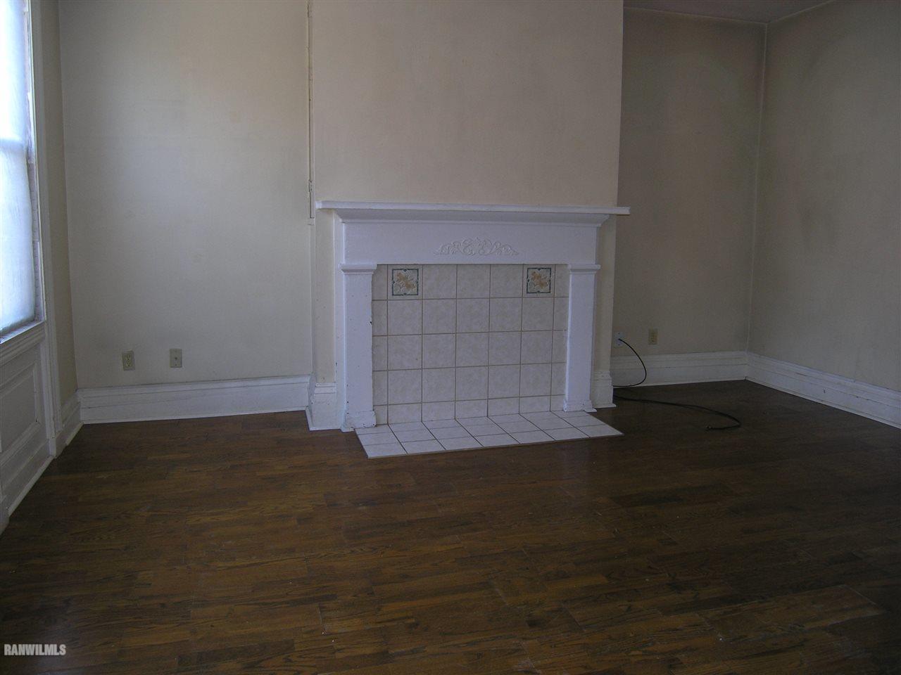 313 South Bench Street Galena, IL 61036 - Photo 7 of 19 a view of empty room with wooden floor and fireplace
