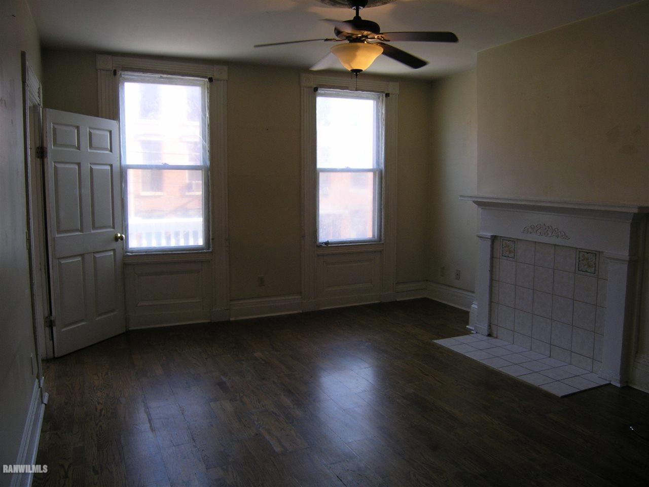 313 South Bench Street Galena, IL 61036 - Photo 8 of 19 a view of an empty room with wooden floor and a window