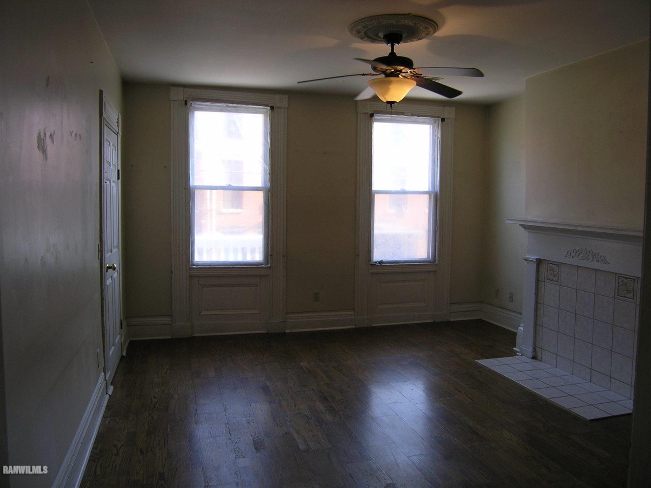 313 South Bench Street Galena, IL 61036 - Photo 10 of 19 a view of an empty room with wooden floor and a window