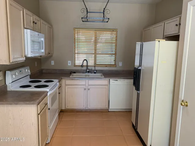a kitchen with a sink stove and refrigerator