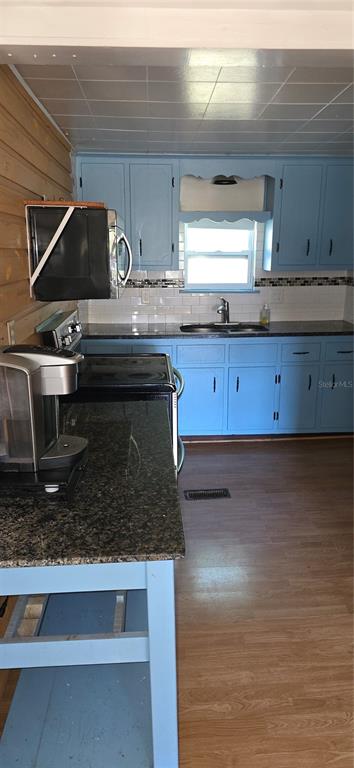 315 Virginia Street Frostproof, FL 33843 - Photo 11 of 23 a kitchen with granite countertop a stove and a sink