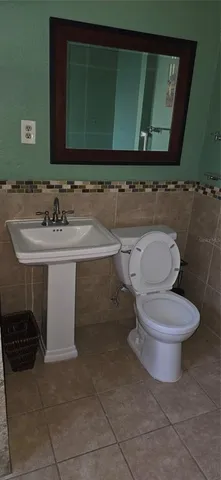 a bathroom with a sink a toilet and bathtub