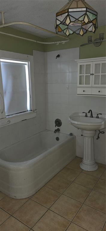 315 Virginia Street Frostproof, FL 33843 - Photo 16 of 23 a bathroom with a sink a toilet and bathtub