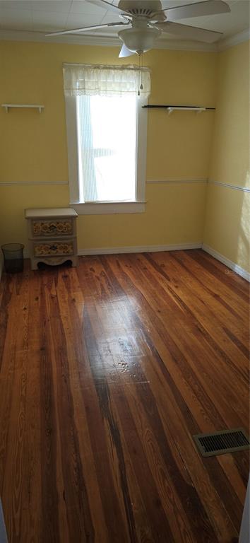 315 Virginia Street Frostproof, FL 33843 - Photo 5 of 23 a view of a room with wooden floor and a window