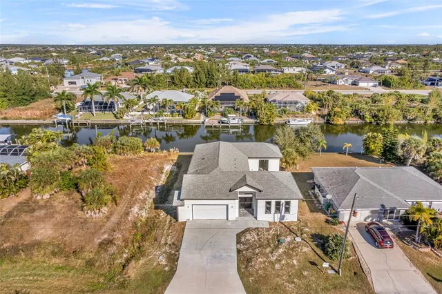 an aerial view of a house with a lake view