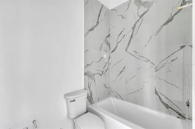 a bathroom with a toilet and tub