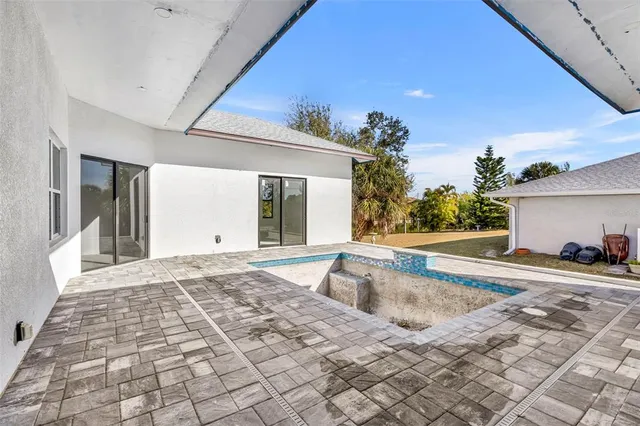 a view of a house with backyard and sitting area