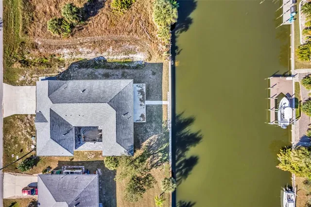 an aerial view of a house with a yard basket ball court and outdoor seating
