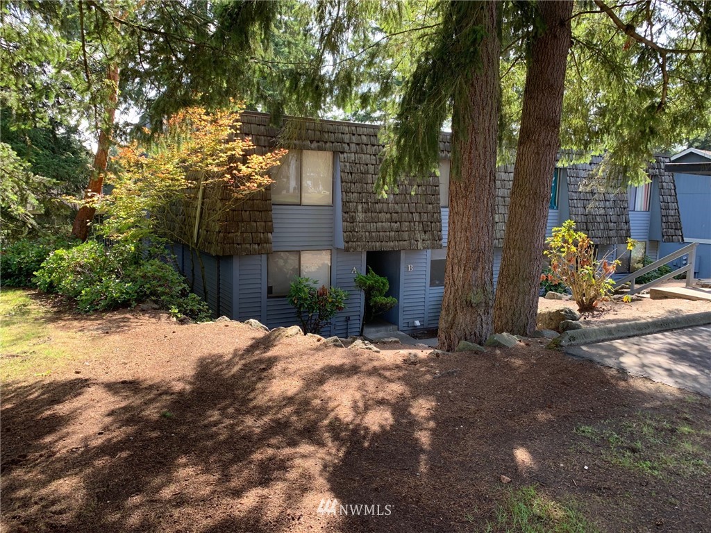 29 South 341st Place, Unit AD Federal Way, WA 98003 - Photo 4 of 4 a front view of a house with a yard and tree
