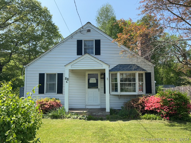 18 Hillside Road Old Lyme, CT 06371 - Photo 1 of 1 a front view of house with yard and trees around