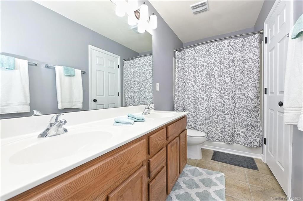 231 Primrose Walk Fort Mill, SC 29715 - Photo 11 of 34 a bathroom with a double vanity sink mirror and shower