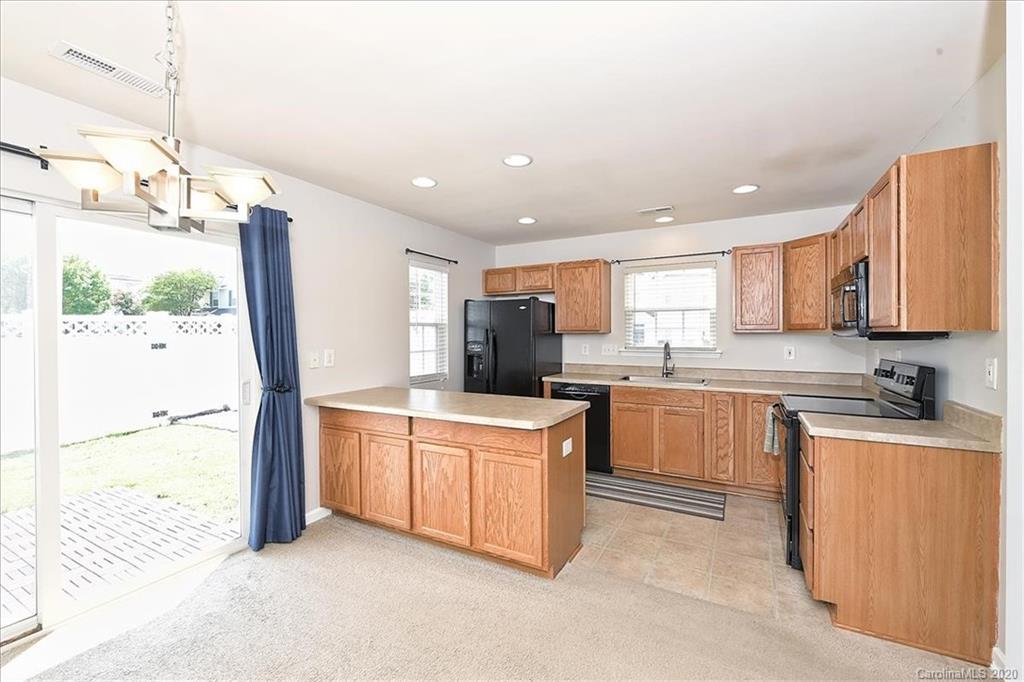 231 Primrose Walk Fort Mill, SC 29715 - Photo 20 of 34 a kitchen with stainless steel appliances granite countertop a stove a sink and a refrigerator