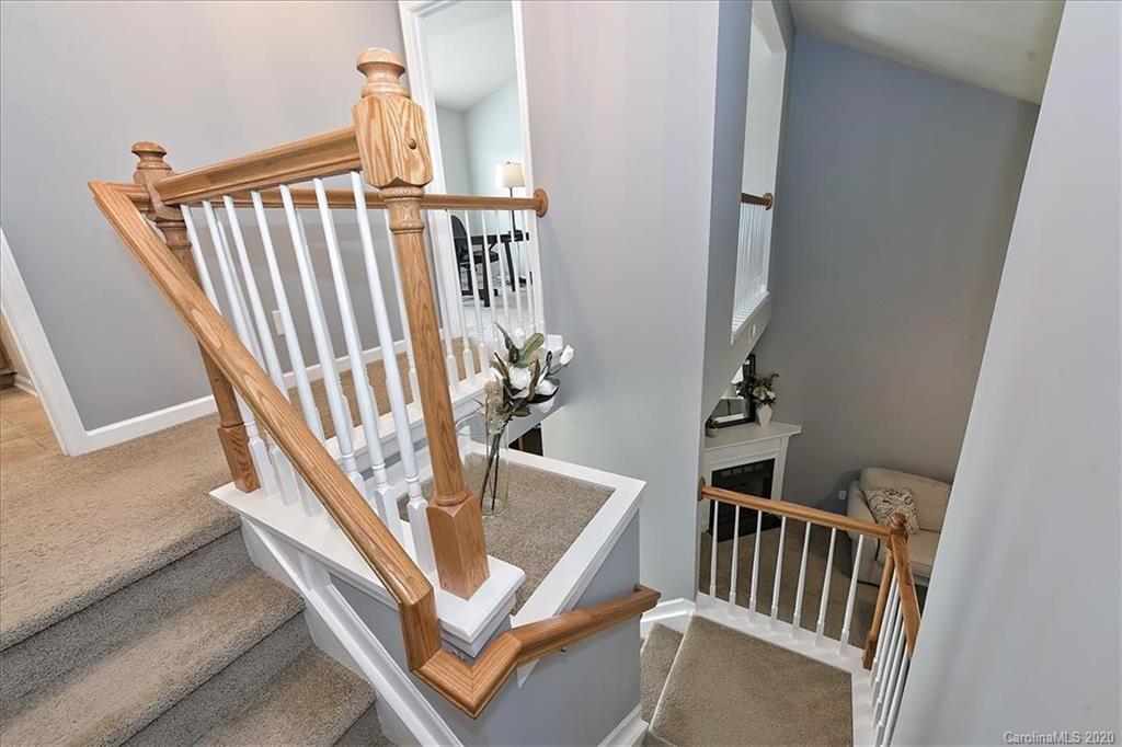 231 Primrose Walk Fort Mill, SC 29715 - Photo 25 of 34 a view of staircase with lots of frames on wall and a potted plant