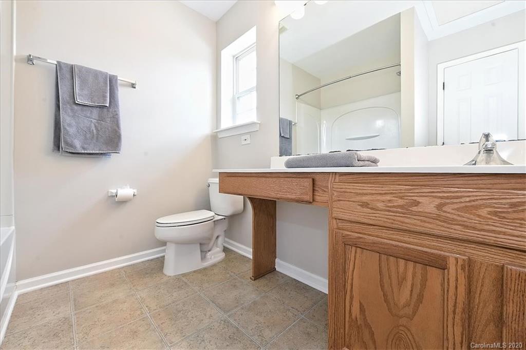 231 Primrose Walk Fort Mill, SC 29715 - Photo 30 of 34 a bathroom with a sink a toilet and mirror