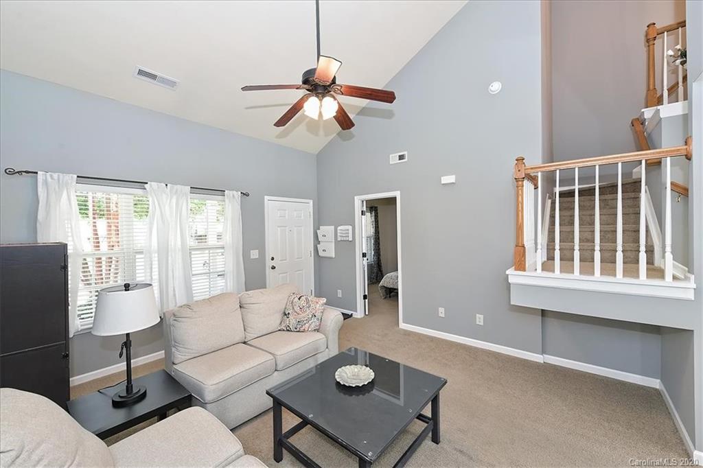 231 Primrose Walk Fort Mill, SC 29715 - Photo 7 of 34 a living room with furniture a chandelier fan and a window
