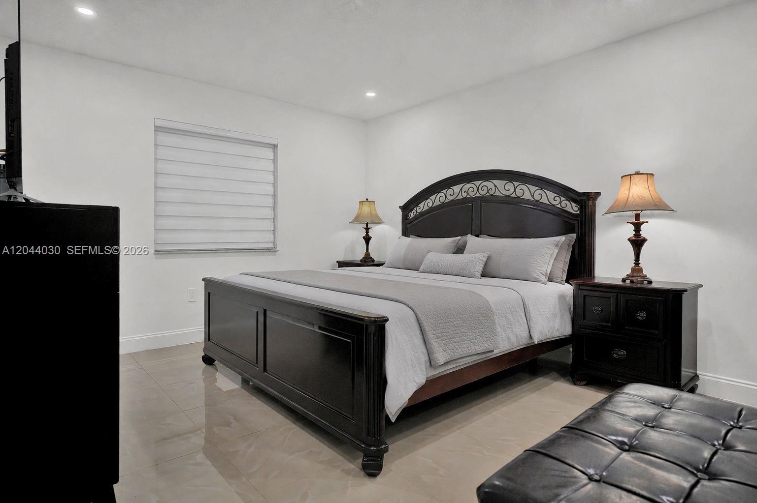 12551 Southwest 223rd Street Miami, FL 33170 - Photo 15 of 35 a bedroom with a bed and a table