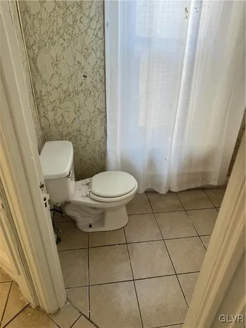 a kitchen with granite countertop a sink stove and cabinets