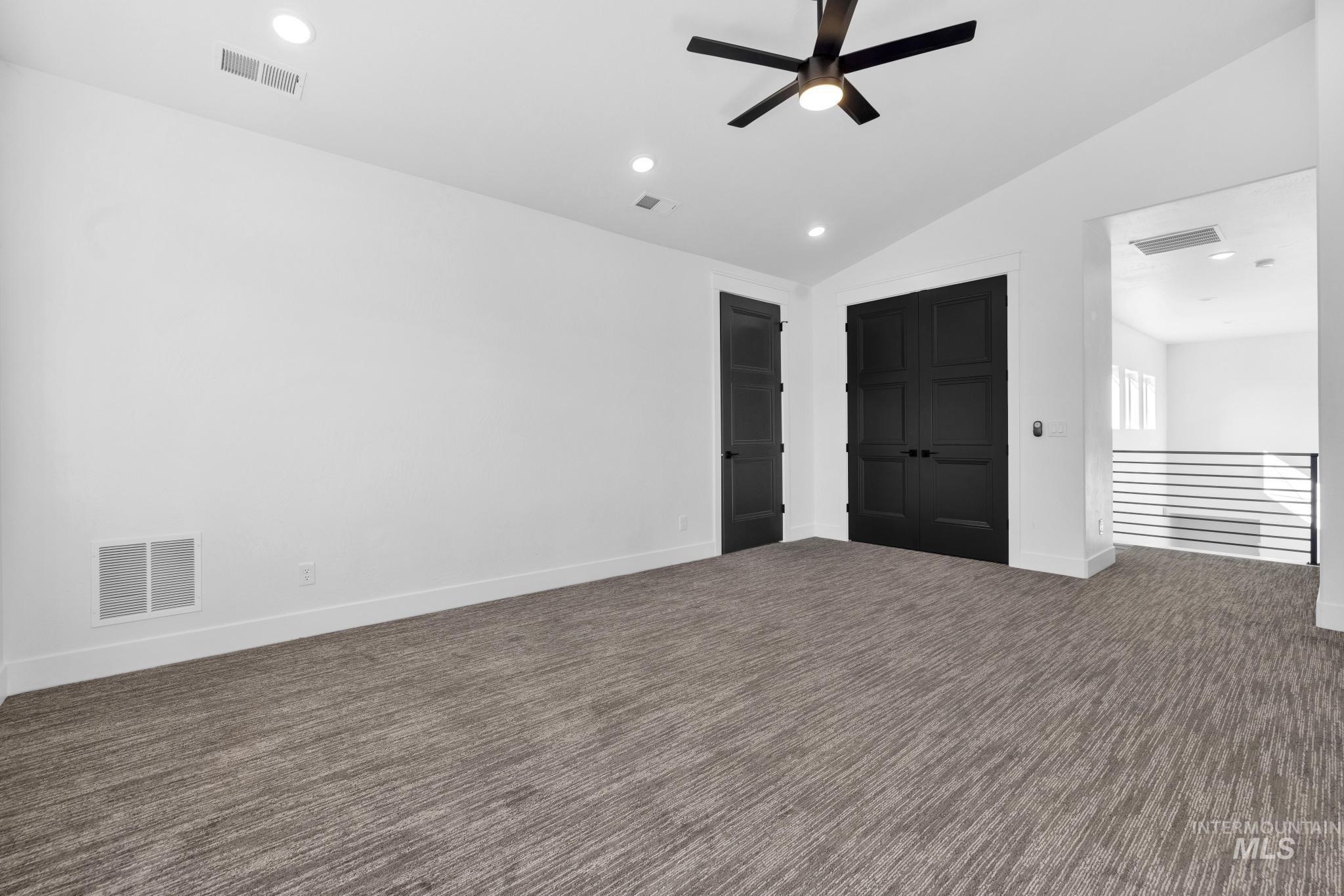 4280 Rim Vista Road Filer, ID 83328 - Photo 33 of 50 Recessed lighting, sloped ceiling, contemporary ceiling fan, dark paneled doors, and gray patterned carpeting