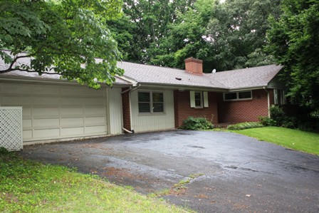 1731 Rutrough Road Southeast Roanoke, VA 24014 - Photo 28 of 34 a front view of a house with a garden and yard