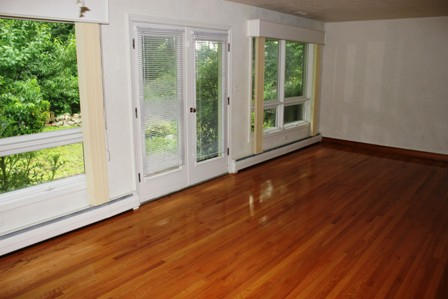 1731 Rutrough Road Southeast Roanoke, VA 24014 - Photo 7 of 34 a view of an empty room with wooden floor and a window