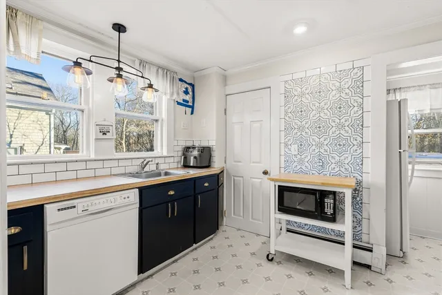 a kitchen with stainless steel appliances a stove sink and cabinets