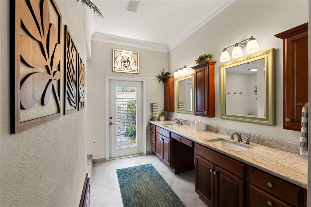 6936 River Road New Port Richey, FL 34652 - Photo 42 of 93 a spacious bathroom with a granite countertop sink and a mirror