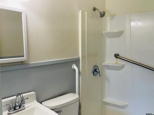 a bathroom with a toilet and a shower