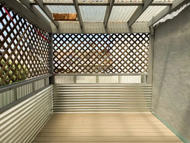 a view of a balcony with wooden floor