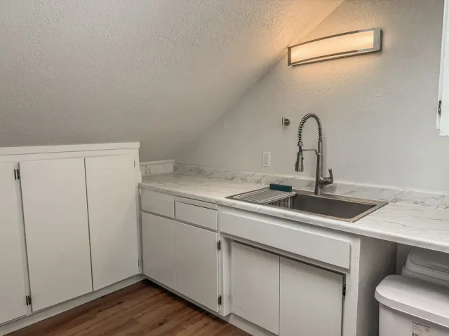 a kitchen with a sink and cabinets