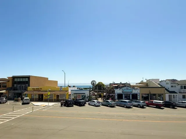 a view of a street with a building and trees in the background
