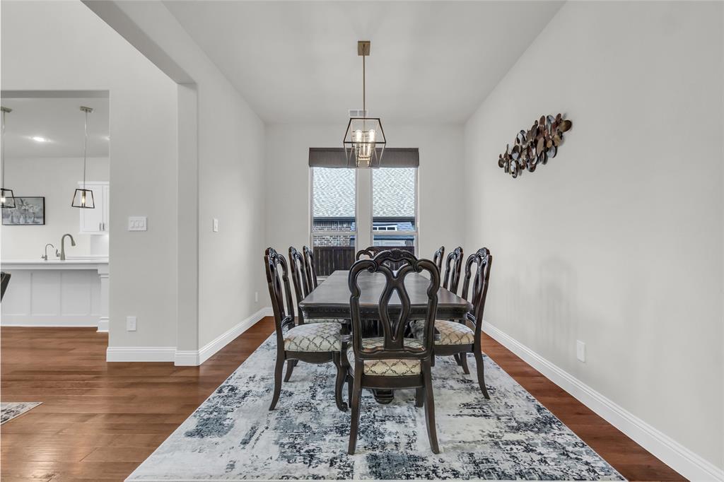3511 Solaro Lane Rockwall, TX 75087 - Photo 13 of 40 a view of a dining room with furniture window and wooden floor