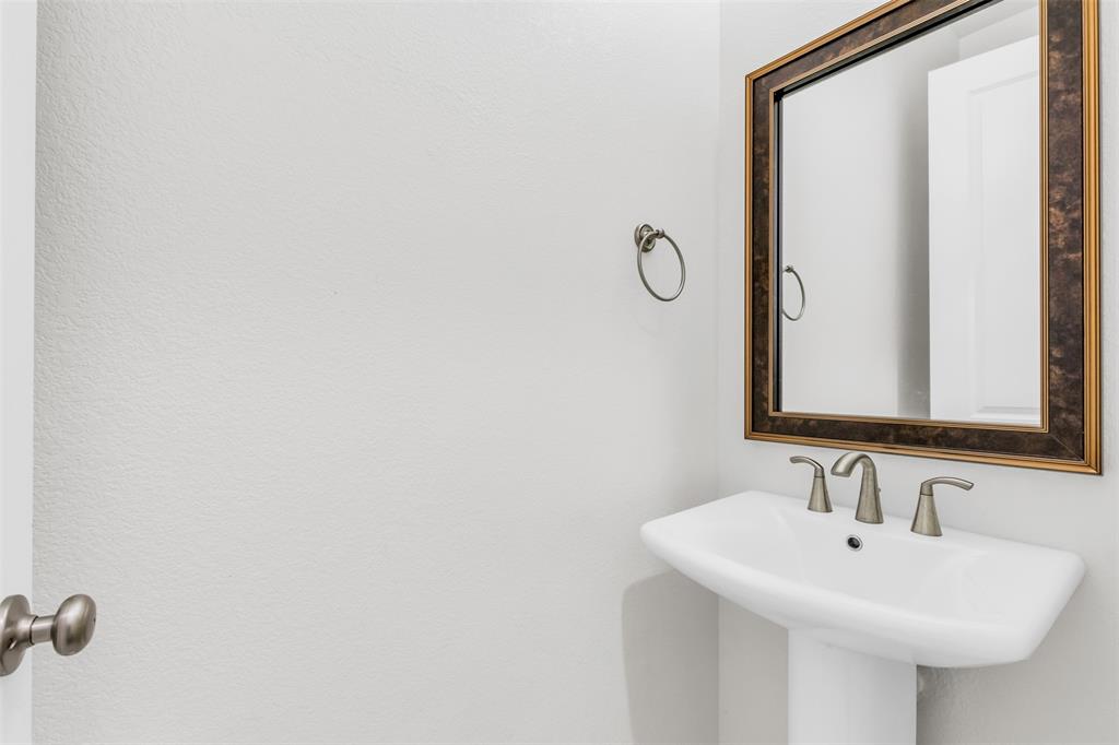 3511 Solaro Lane Rockwall, TX 75087 - Photo 15 of 40 a bathroom with a sink and a mirror
