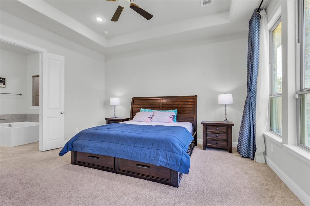 3511 Solaro Lane Rockwall, TX 75087 - Photo 16 of 40 a bedroom with a bed and a cabinets