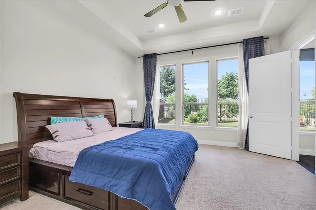 a bedroom with a large bed and a large window