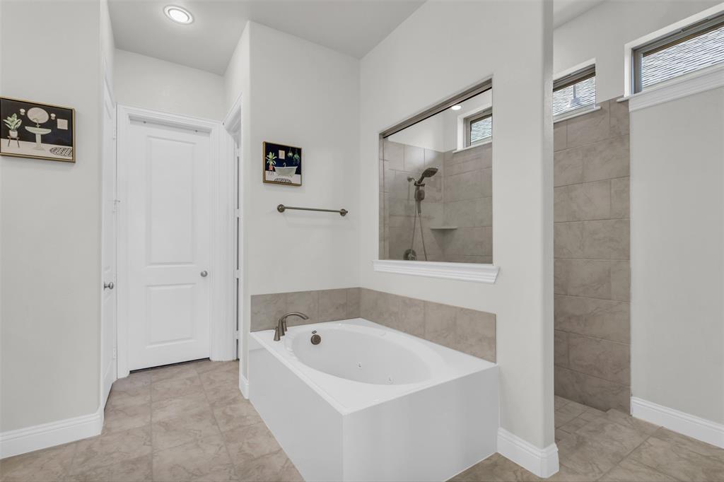 3511 Solaro Lane Rockwall, TX 75087 - Photo 21 of 40 a bathroom with a bathtub and shower