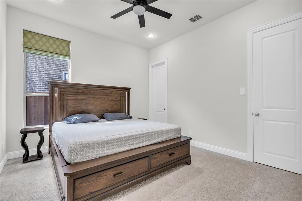 3511 Solaro Lane Rockwall, TX 75087 - Photo 27 of 40 a bedroom with a bed and a ceiling fan