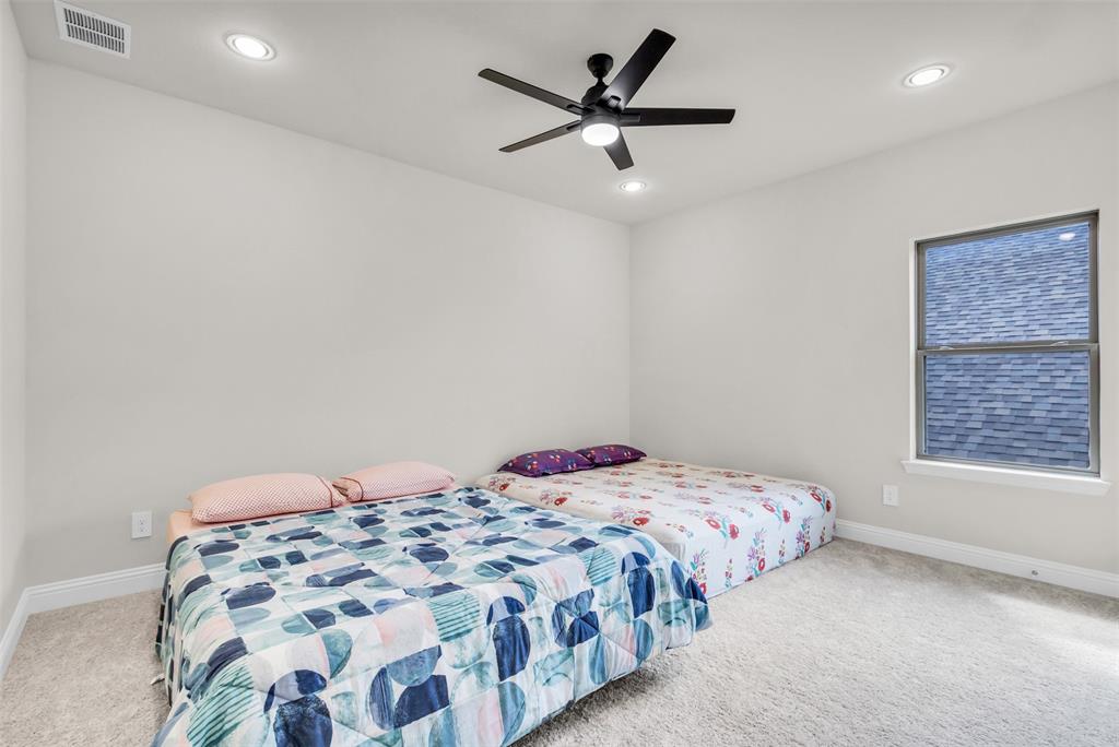 3511 Solaro Lane Rockwall, TX 75087 - Photo 28 of 40 a bedroom with a bed and a window