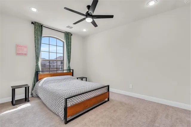 a bed sitting in a room next to a window